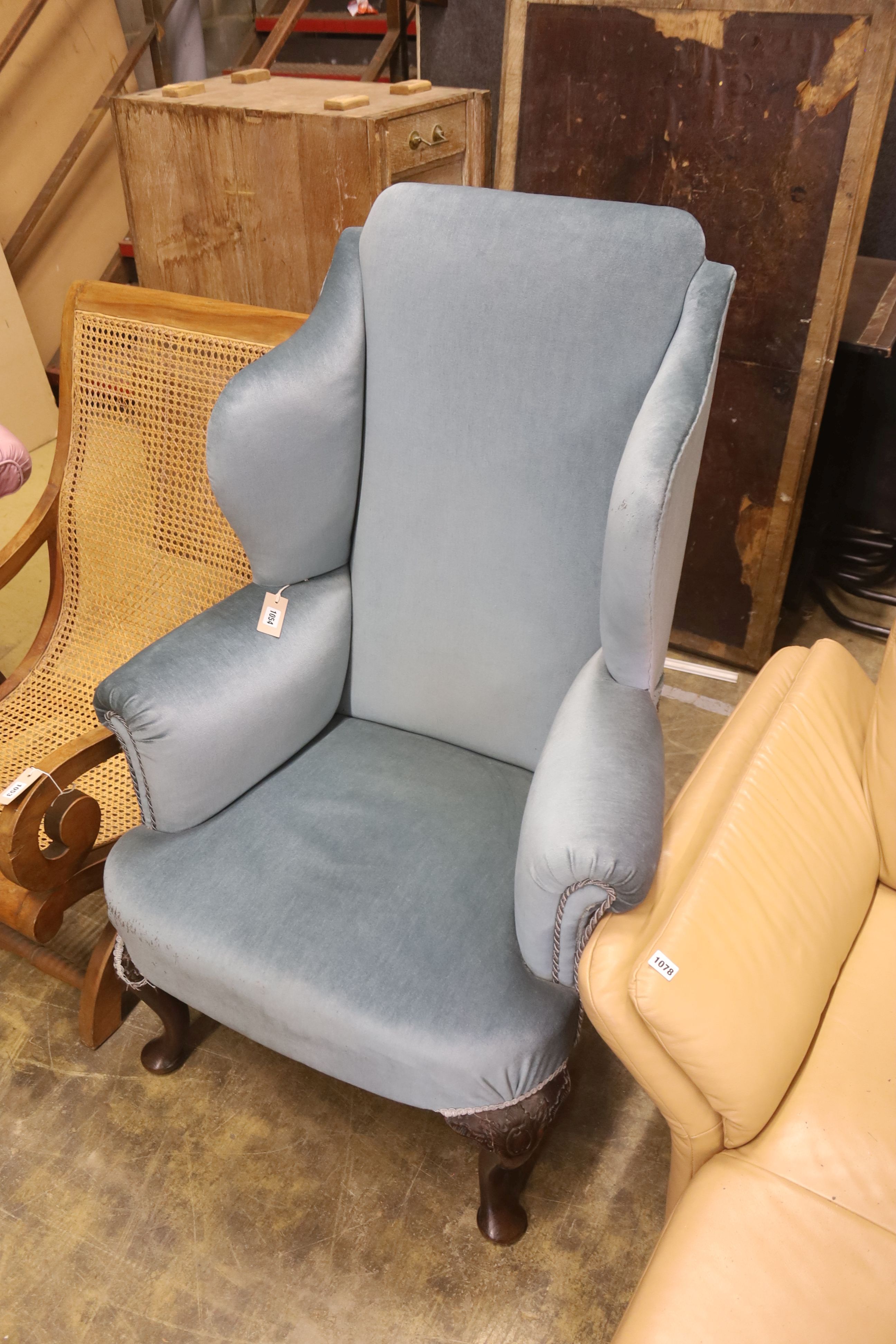 A 1920's Queen Anne style upholstered wing armchair, width 80cm, depth 70cm, height 121cm